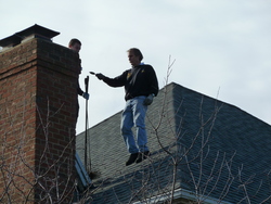 Chimney sweeps on roof