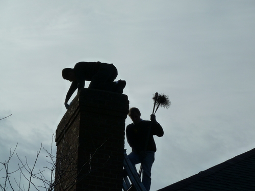 Chimney sweeps on roof